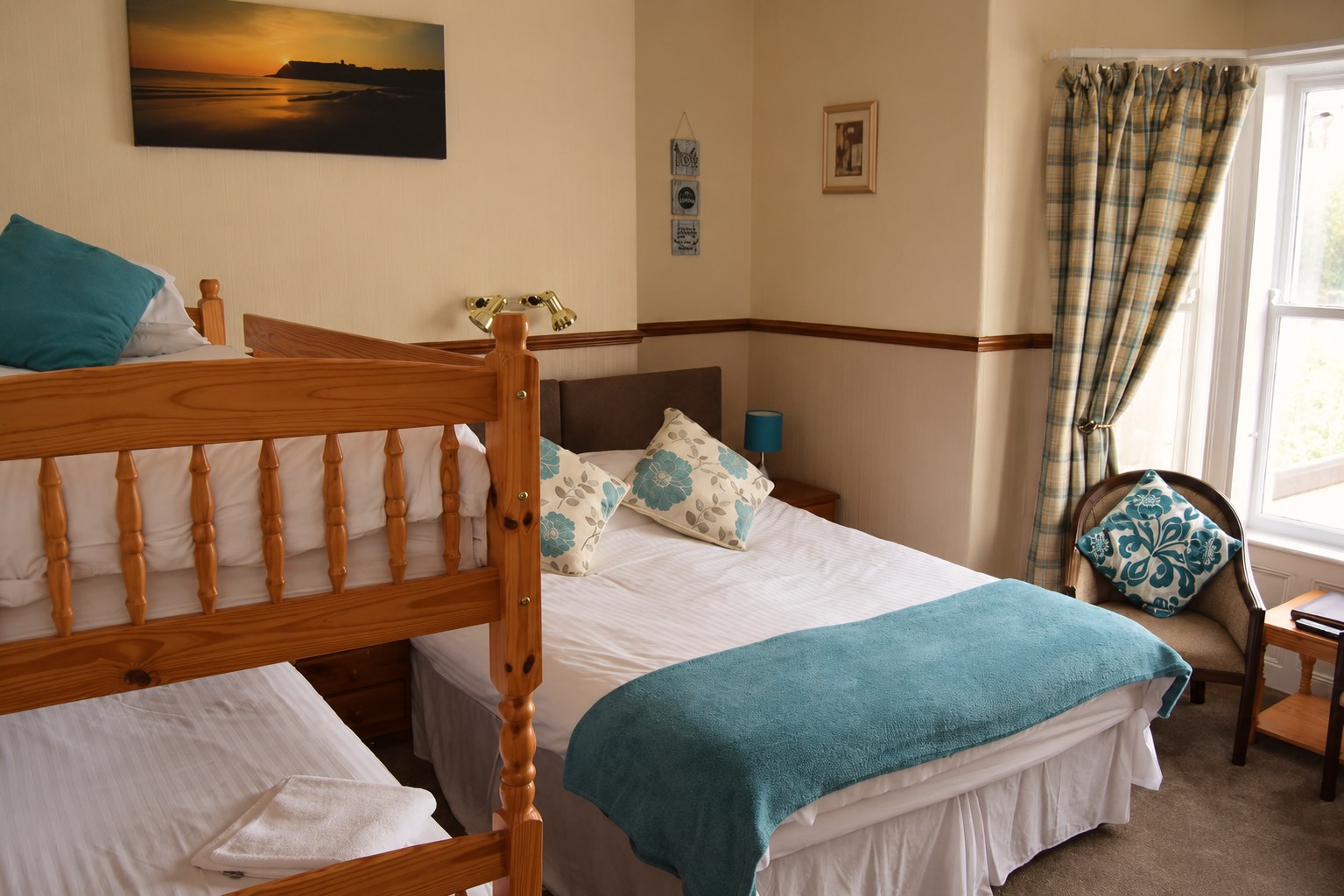 A family room with a double bed and bunk beds